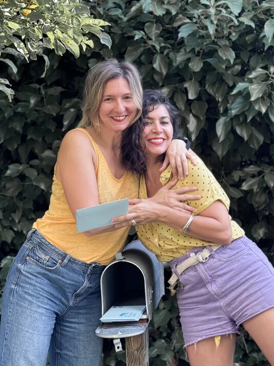 María y Laura junto a un buzón